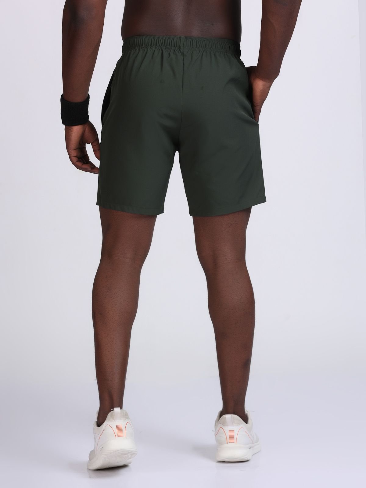 Back view of olive green athletic Feather LaserTech shorts with elastic waistband.