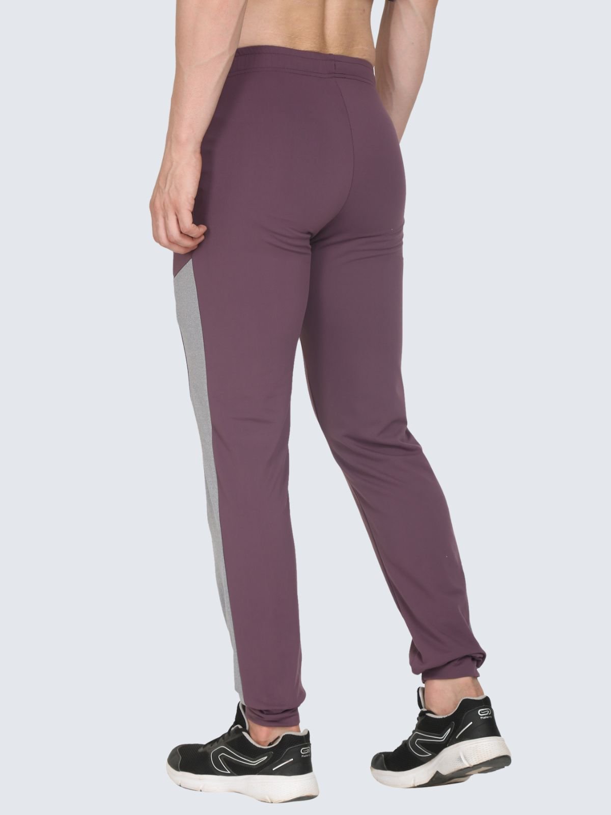 Back three-quarter view of T-Pant Ankel Ribbed Prussian Plum jogger pants with grey side panel on a white background