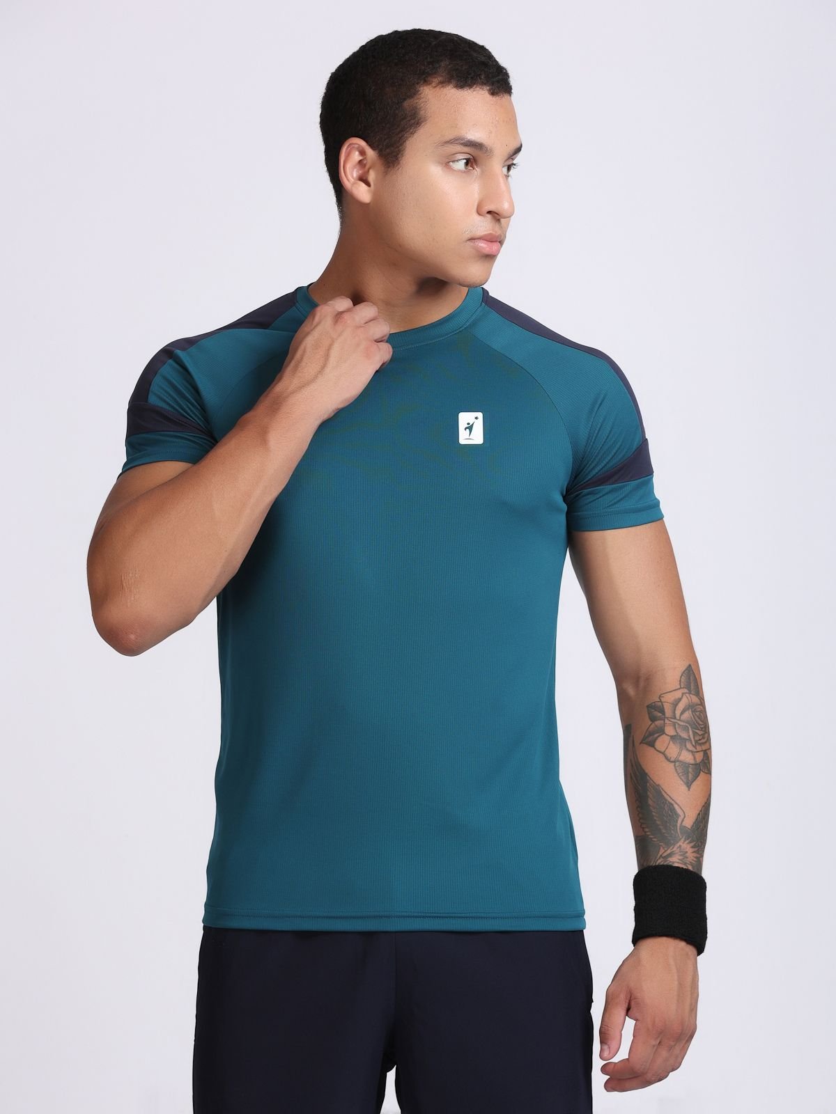 Front view of a man wearing a teal athletic t-shirt AirFeel with navy shoulder panels.