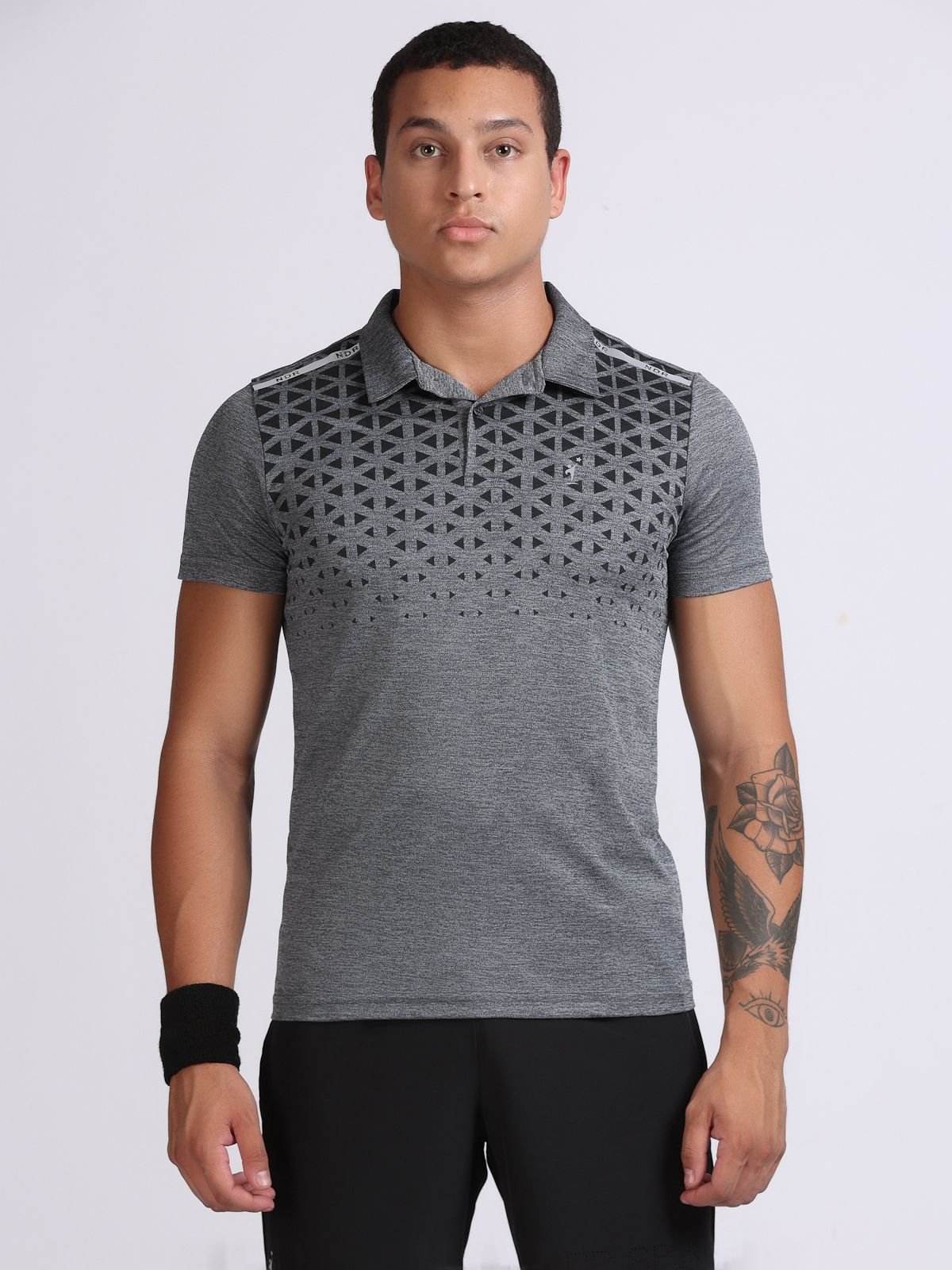 Male model wearing dark grey polo T-shirt Milanz Illustrated with geometric triangle print, front view