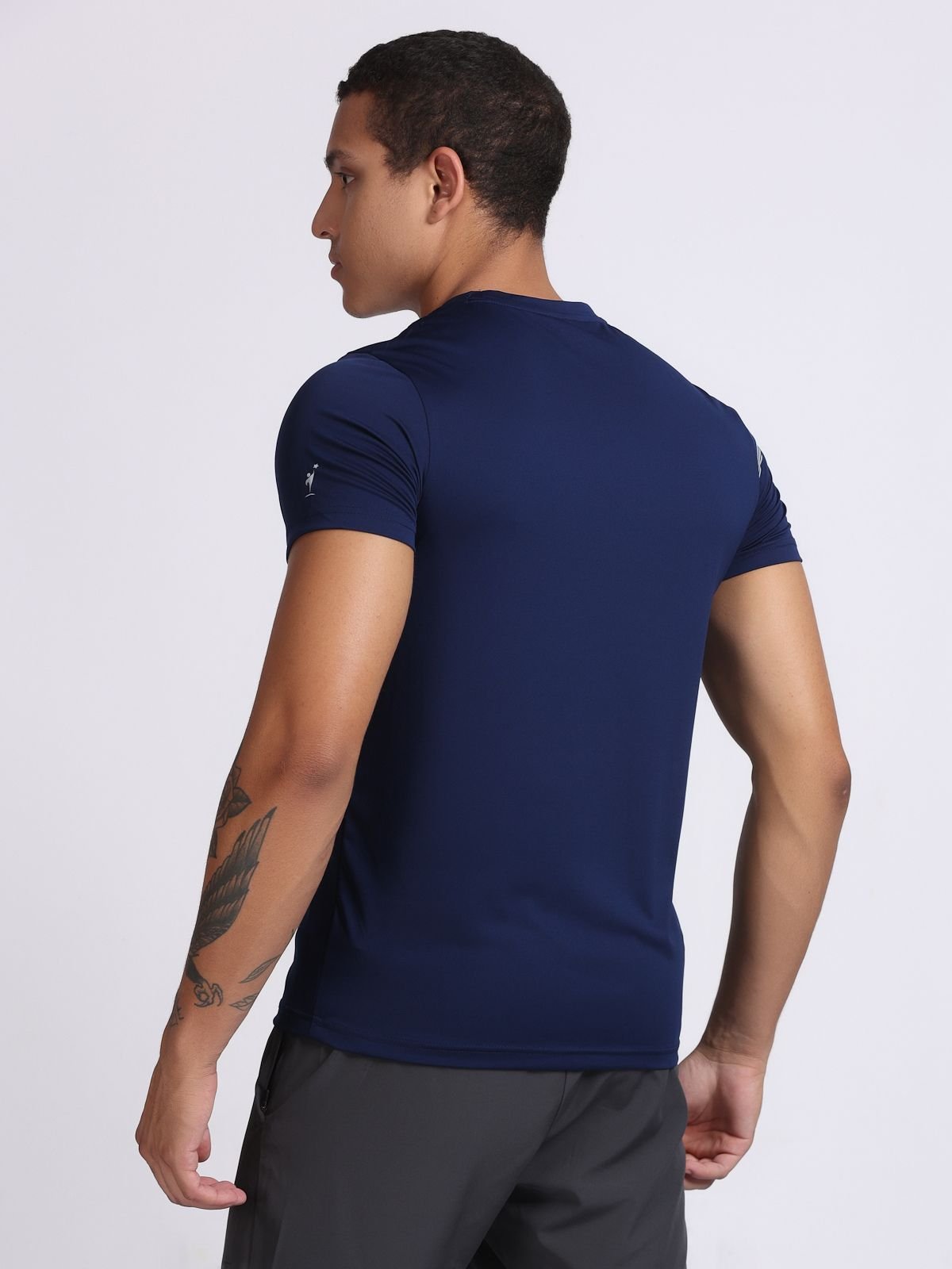 Close-up of sleeve brand logo of NDR SPORT detail on a navy NDR Blitz t-shirt.