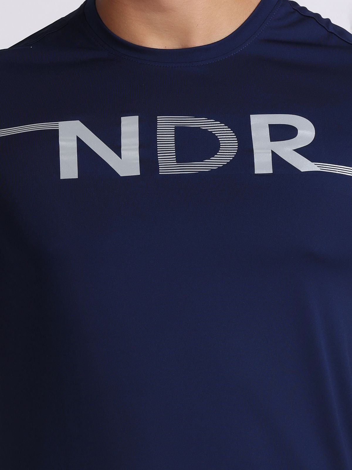 Close-up of the NDR design across the chest on a navy athletic t-shirt of NDR SPORT.