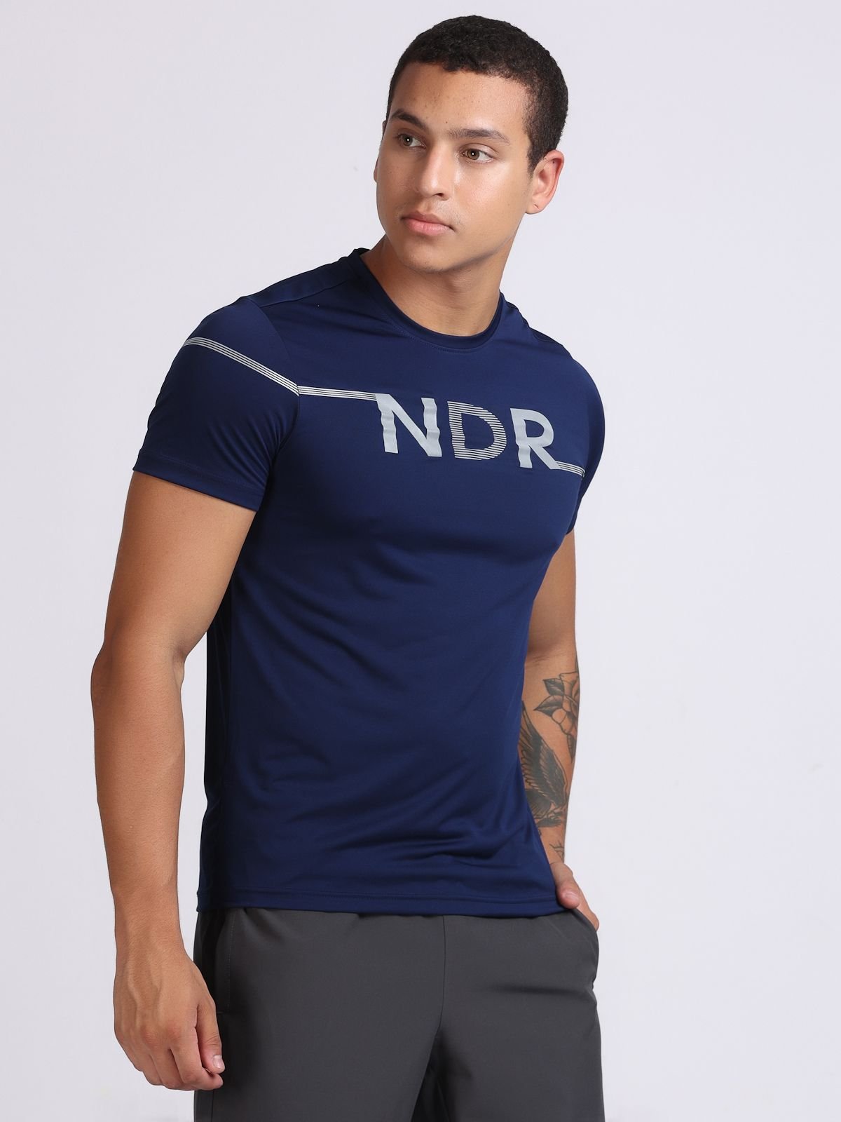 Right-side view of a man wearing a navy NDR Blitz t-shirt.
