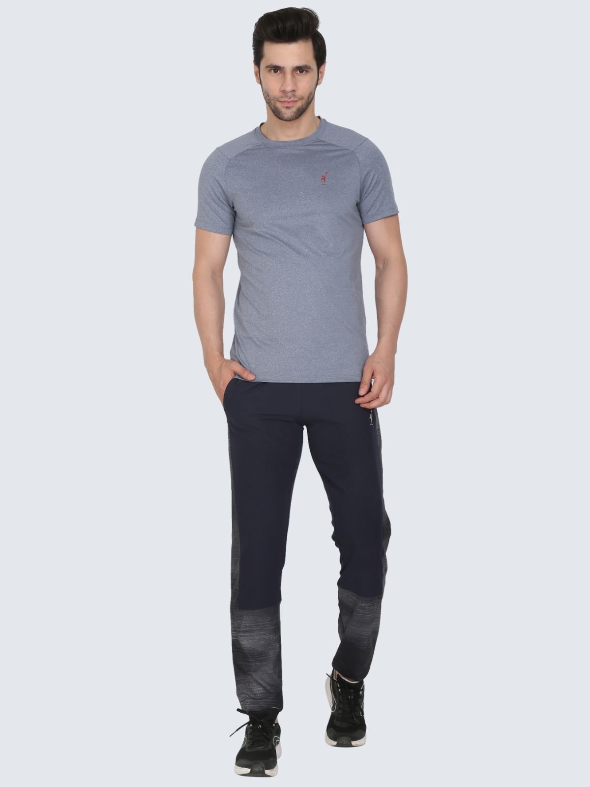 Full-body male model in grey cool N comfort tee wearing Lite Subly navy athletic pants with grey gradient lower panels on a white background