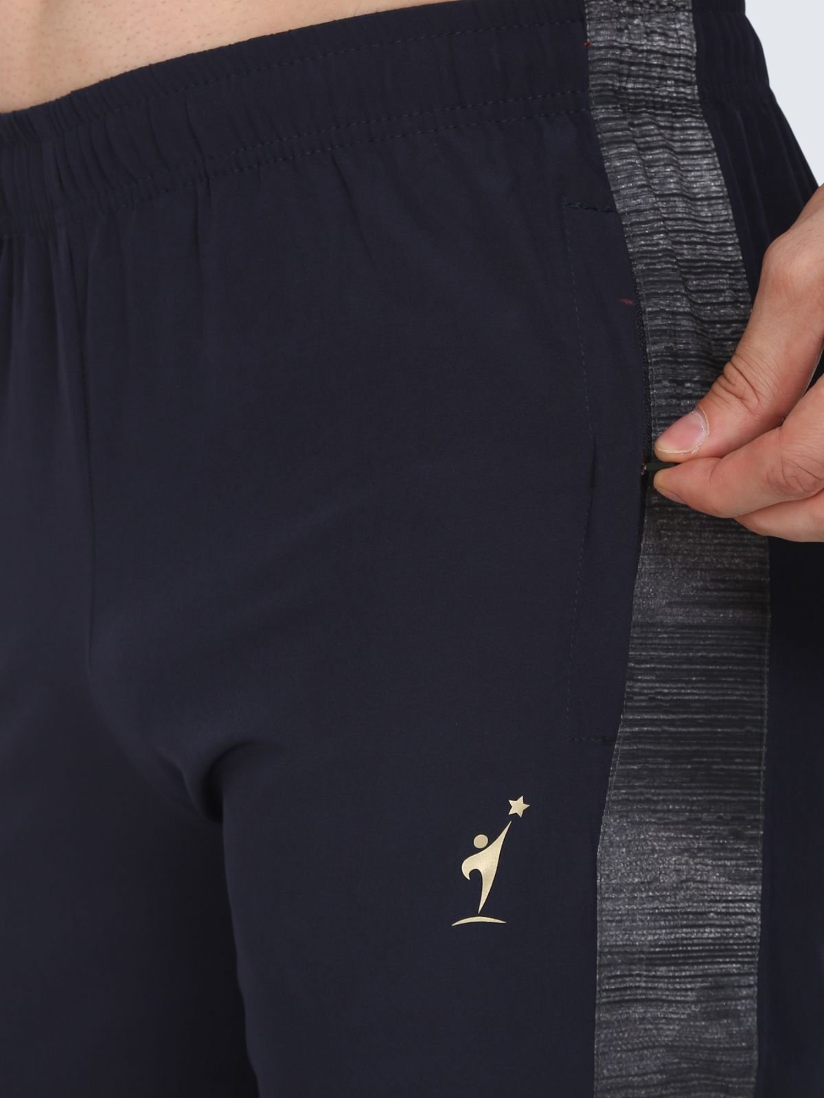 Close-up of zip pocket on Lite Subly navy athletic pants with textured side stripe and NDR SPORT logo
